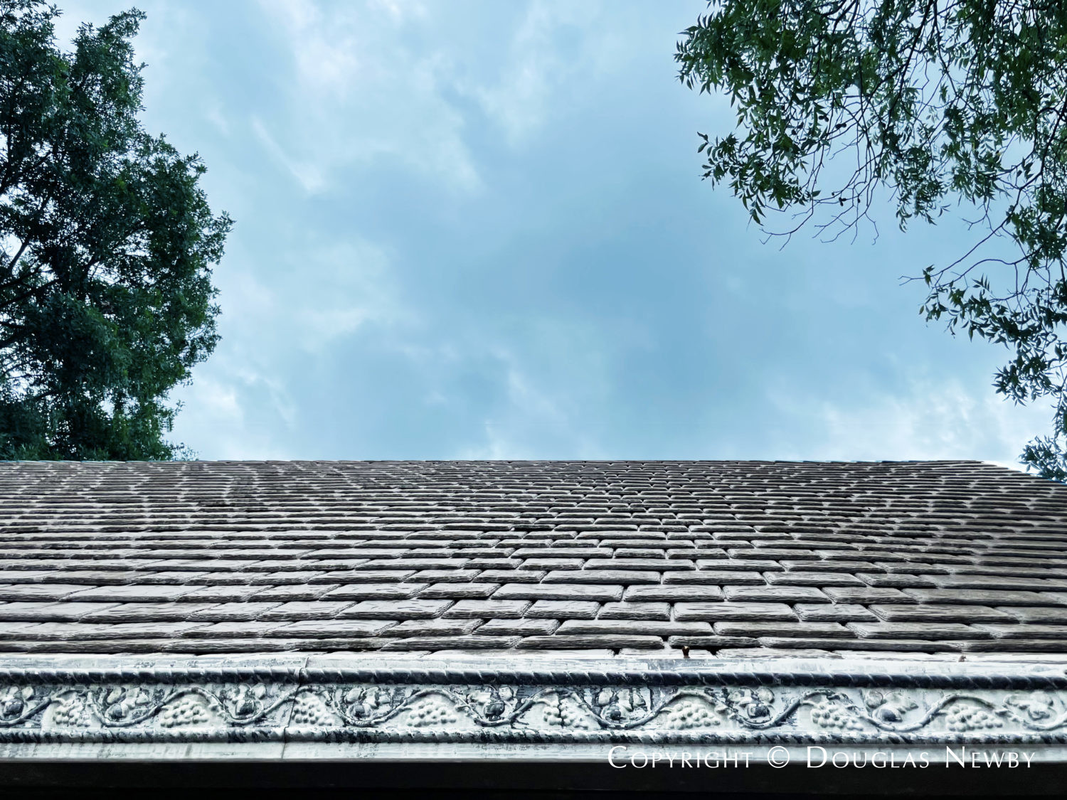 Slate roof and decorative trim on Highland Park home, a preservation success.