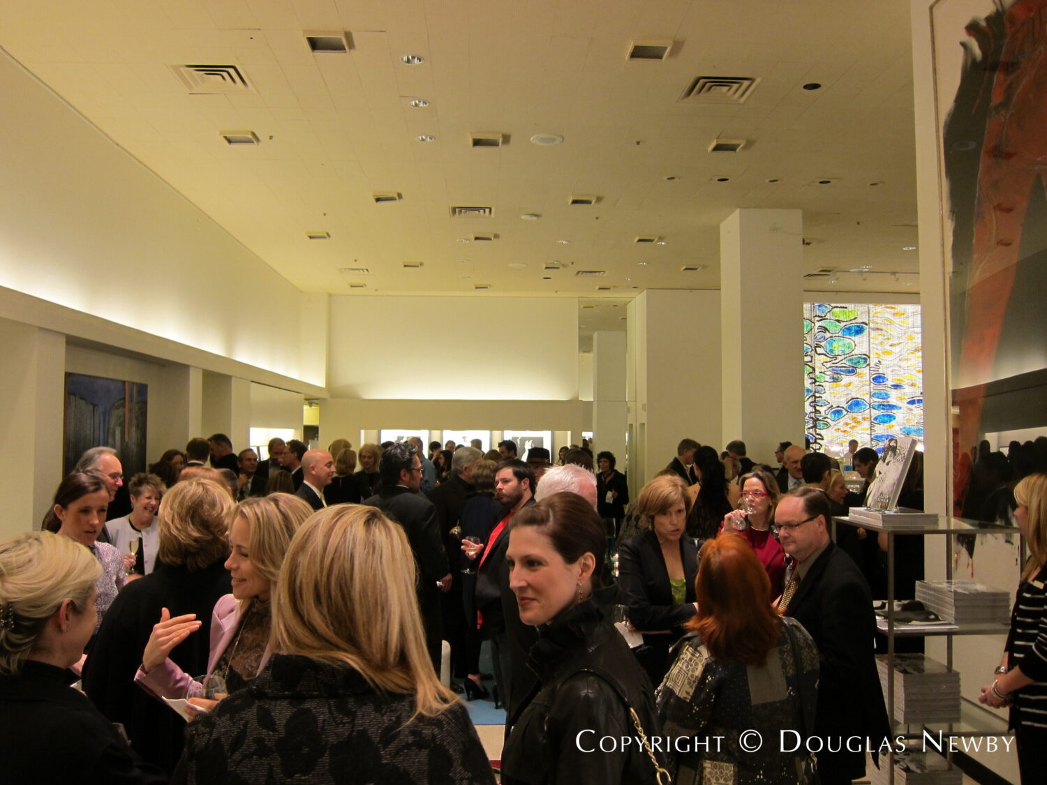 Patrons of Dallas International Art Fair fill the downtown Dallas Neiman Marcus tore.