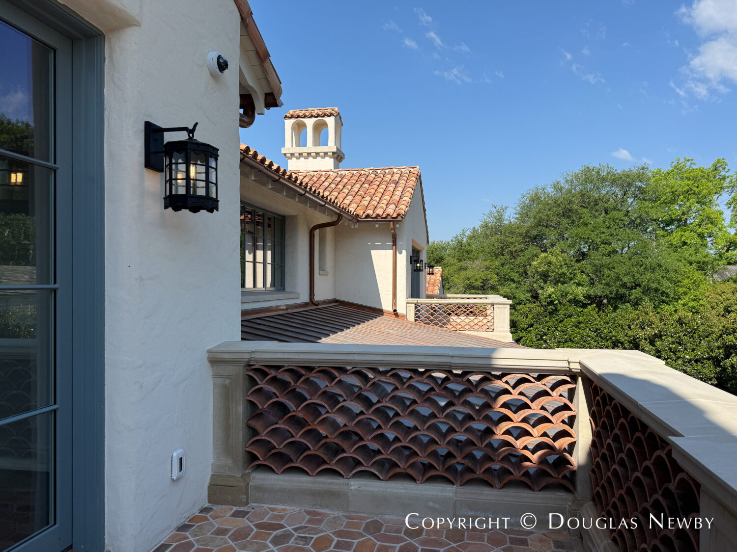 Bedroom balconies at this Spanish Revival style home at 4400 Belfort Place in Highland Park, Dallas, Texas.